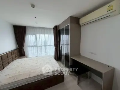 Modern bedroom with large window, air conditioning, and stylish furniture in a bright apartment.