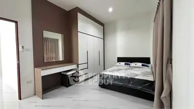 Modern bedroom with sleek wardrobe and stylish vanity in a minimalist design.