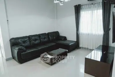 Modern living room with black leather sofa and sleek furniture