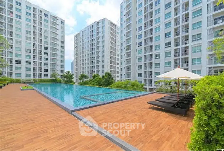 Luxurious apartment complex with a stunning pool and modern architecture.