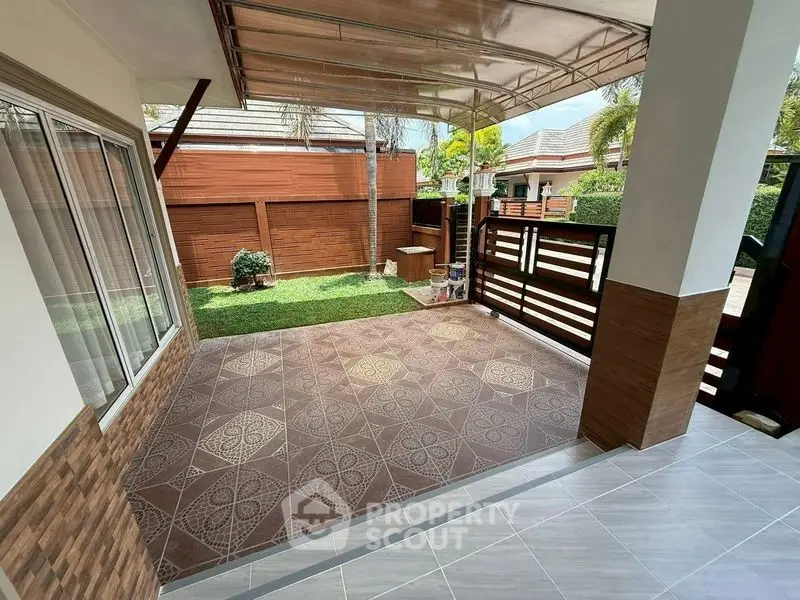 Charming patio with decorative tiles and garden view in modern home