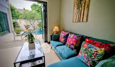 Charming living room with vibrant decor and pool view, perfect for relaxation and entertaining.