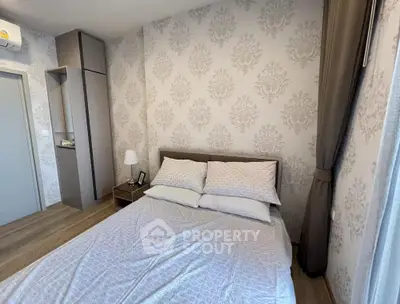 Cozy bedroom with elegant wallpaper and natural light