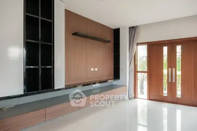 Spacious modern living room with sleek wooden accents and large windows