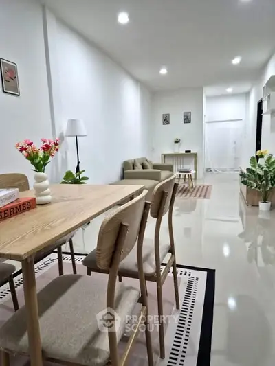Modern open-plan living and dining area with sleek furniture and bright decor.