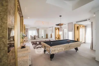 Luxurious living room with pool table and elegant decor in a modern home