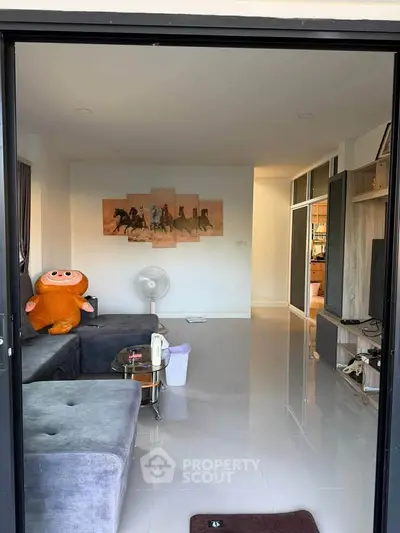 Modern living room with plush sofa and unique wall art, perfect for relaxation.