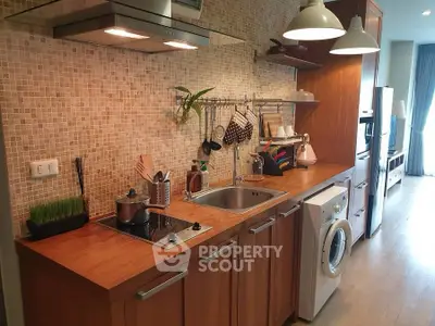 Modern kitchen with wooden cabinets, washing machine, and open layout design.