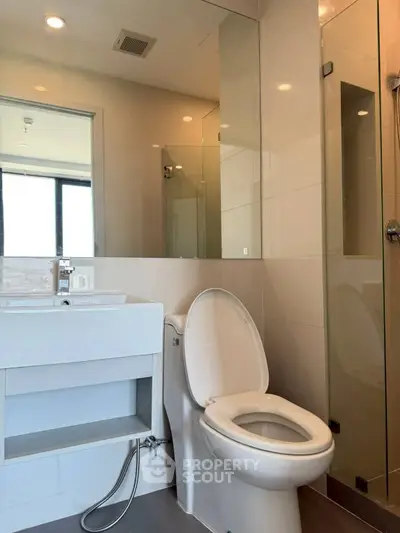 Modern bathroom with sleek fixtures and glass shower enclosure