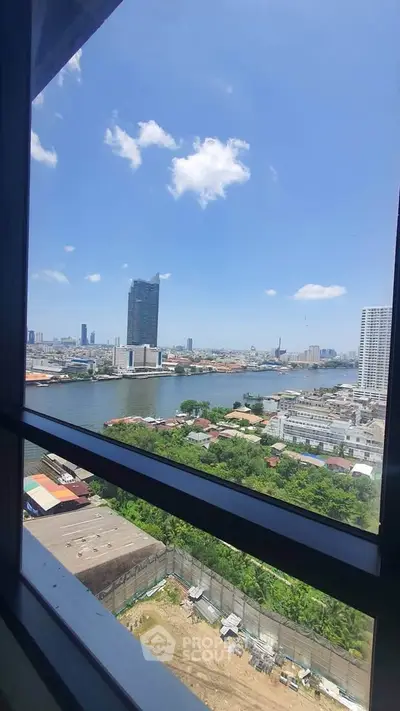 Stunning cityscape view from high-rise window overlooking river and skyline, perfect for urban living.