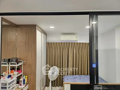 Modern bedroom with sliding glass doors and air conditioning unit