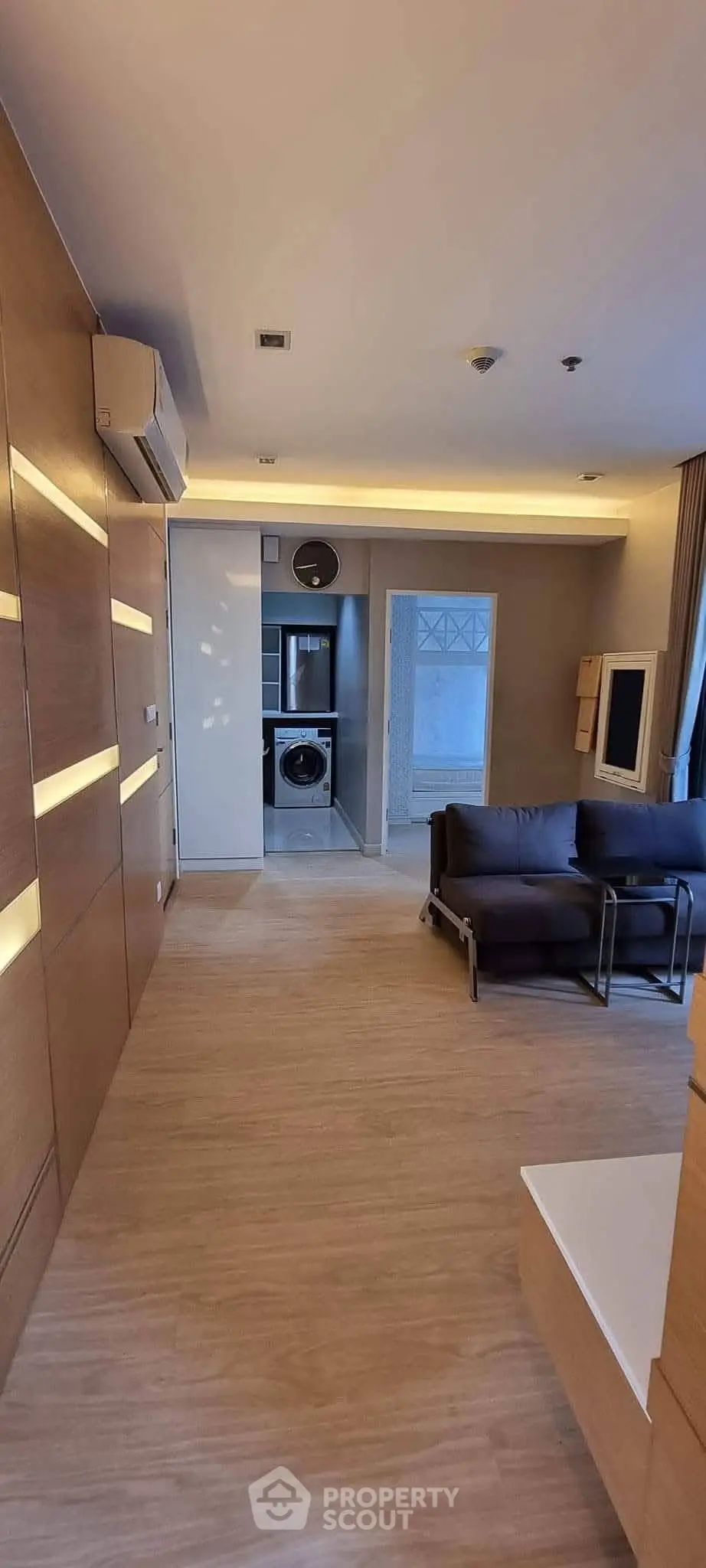 Modern living room with sleek design and in-unit washing machine