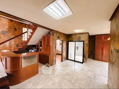 Spacious interior with wooden accents and marble flooring, ideal for a stylish office or reception area.