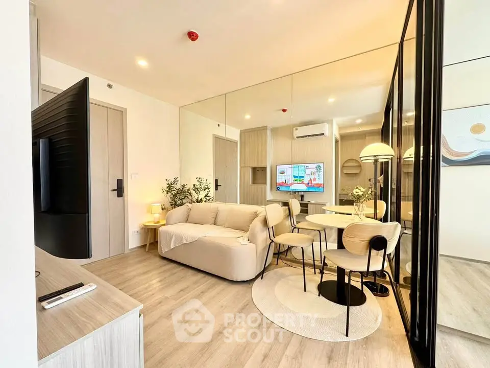 Modern living room with stylish decor and open layout, featuring a cozy sofa and dining area.