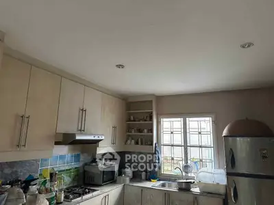 Charming kitchen with modern appliances and ample storage, featuring a gas stove and natural light.