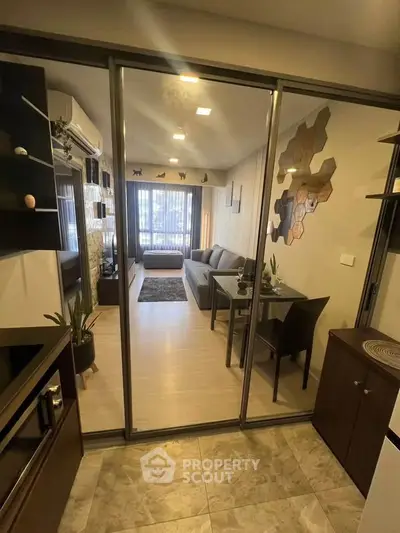 Modern living room with glass partition, stylish decor, and cozy seating area.