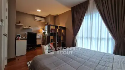 Modern bedroom with study area, featuring elegant curtains and stylish decor.