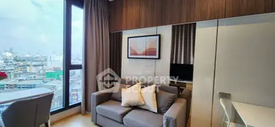 Modern living room with city view, cozy sofa, and stylish decor in high-rise apartment.