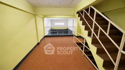 Spacious interior with staircase and tiled flooring, ideal for versatile use.