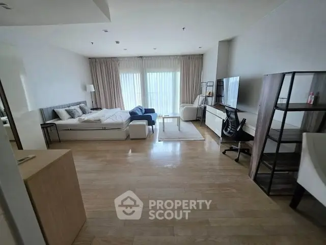 Spacious modern studio apartment with elegant furnishings and natural light.