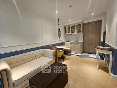 Charming living room with elegant furniture and compact kitchen area