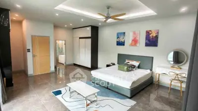 Spacious modern bedroom with stylish decor and ample natural light