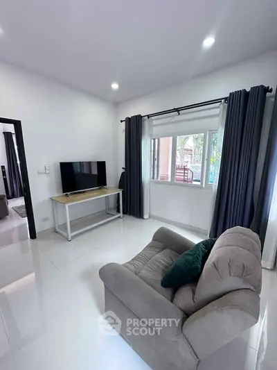 Modern living room with cozy armchair and large window view