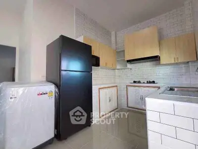 Modern kitchen with sleek appliances and stylish cabinetry in a contemporary home.