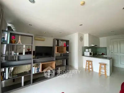 Modern open-plan living room with stylish shelving and kitchen bar stools