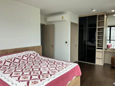 Spacious bedroom with modern design and built-in wardrobe in urban apartment
