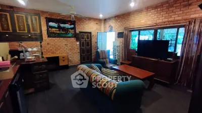 Charming living room with rustic brick walls and cozy seating area, perfect for relaxation.