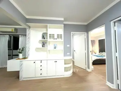 Modern apartment interior with stylish shelving and cozy bedroom view