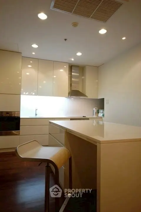 Modern kitchen with sleek cabinetry and stylish bar stool, perfect for contemporary living.