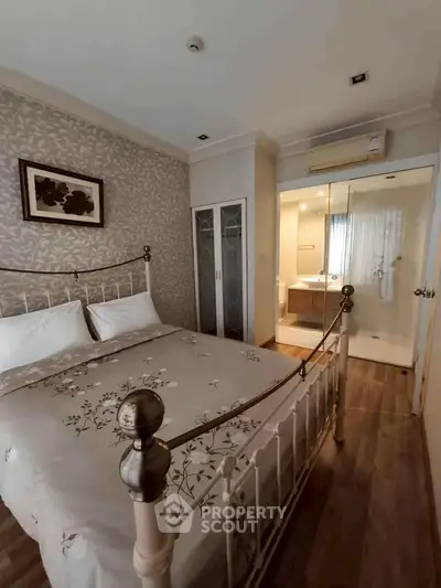 Charming bedroom with elegant decor and ensuite bathroom, featuring a cozy bed and stylish wardrobe.