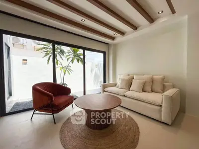 Modern living room with stylish furniture and large windows for natural light.
