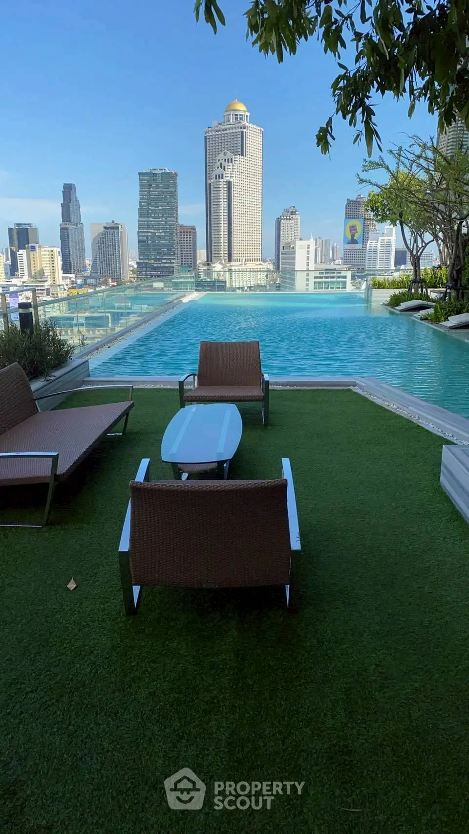 Luxurious rooftop pool with stunning city skyline view, perfect for relaxation and entertainment.