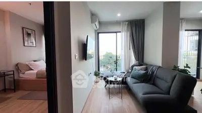 Modern living room with cozy sofa and balcony view in stylish apartment.