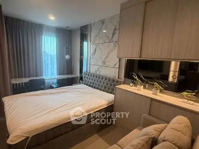 Luxurious bedroom with modern decor and large windows offering city views