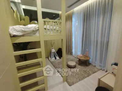 Charming kids' bedroom with loft bed and cozy play area, perfect for family living.