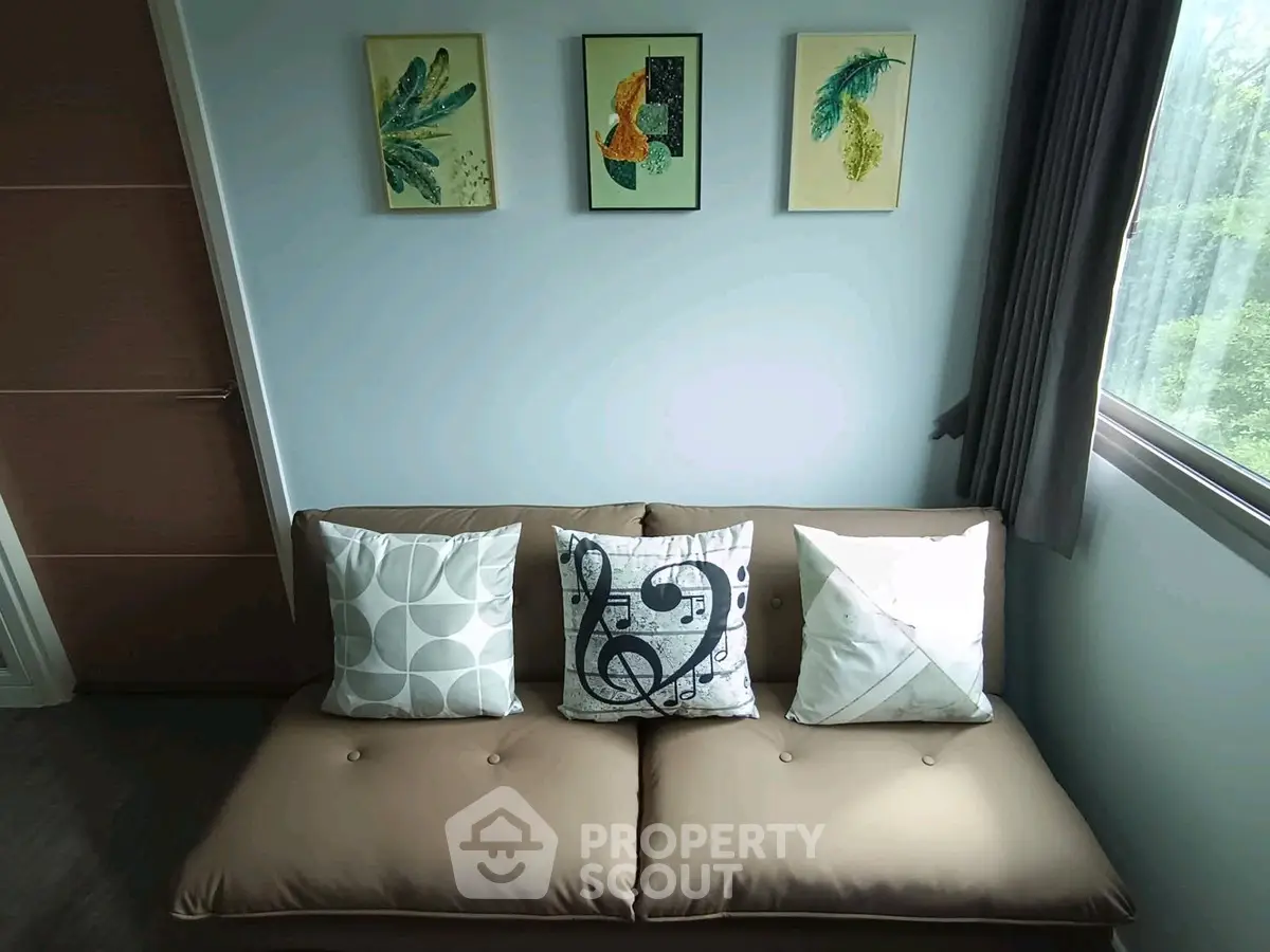 Cozy living room with stylish sofa and artistic wall decor