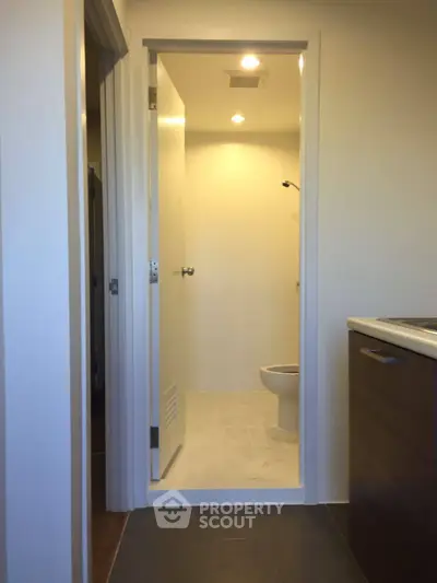 Compact bathroom with modern fixtures and minimalistic design in a contemporary apartment.