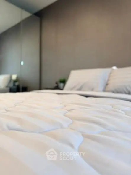 Luxurious bedroom with plush bedding and modern decor, perfect for relaxation and comfort.