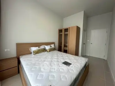 Modern bedroom with wooden furniture and cozy double bed in bright apartment.