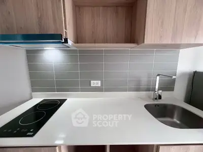 Modern kitchen with sleek induction cooktop and stylish backsplash