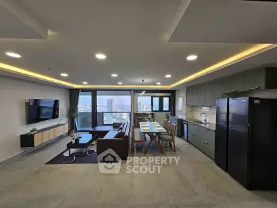 Spacious modern living room with open kitchen and stunning city view