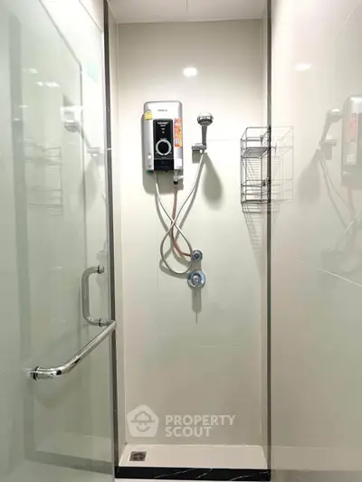 Modern bathroom shower with glass enclosure and water heater in sleek design.