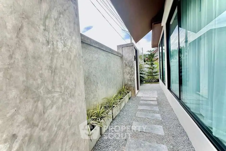 Modern exterior walkway with sleek design and potted plants