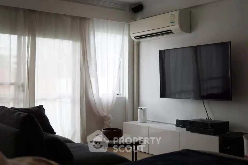 Modern living room with large TV and air conditioning