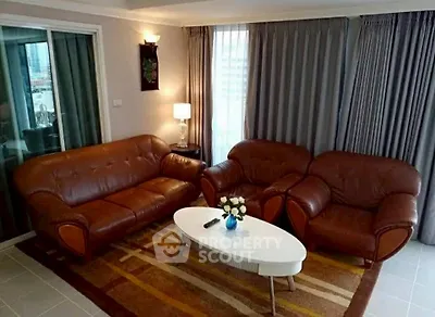Elegant living room with leather sofas and modern decor, perfect for relaxation and entertaining.