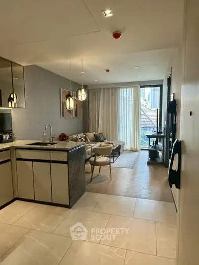 Modern open-plan kitchen and living room with city view and elegant decor.